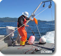 Oceanographer Rick Fletcher deploys a research mooring from R/V Tatoosh.