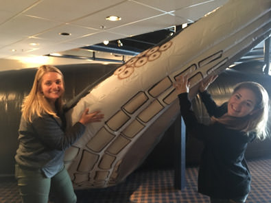 americorps service corps members posing with a humpback whale replica
