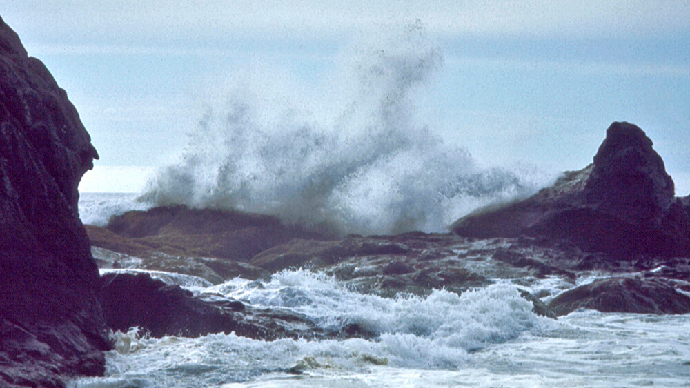 Huge waves crash onto the rocky shoreline