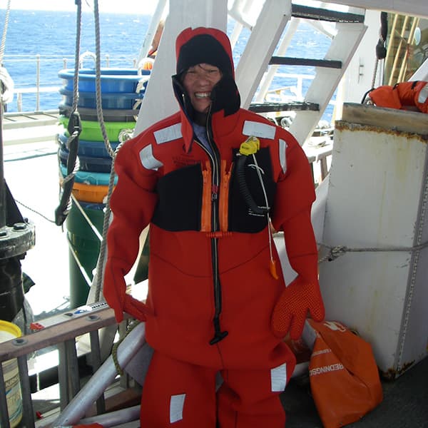 teacher in gumby suit on the deck of a ship